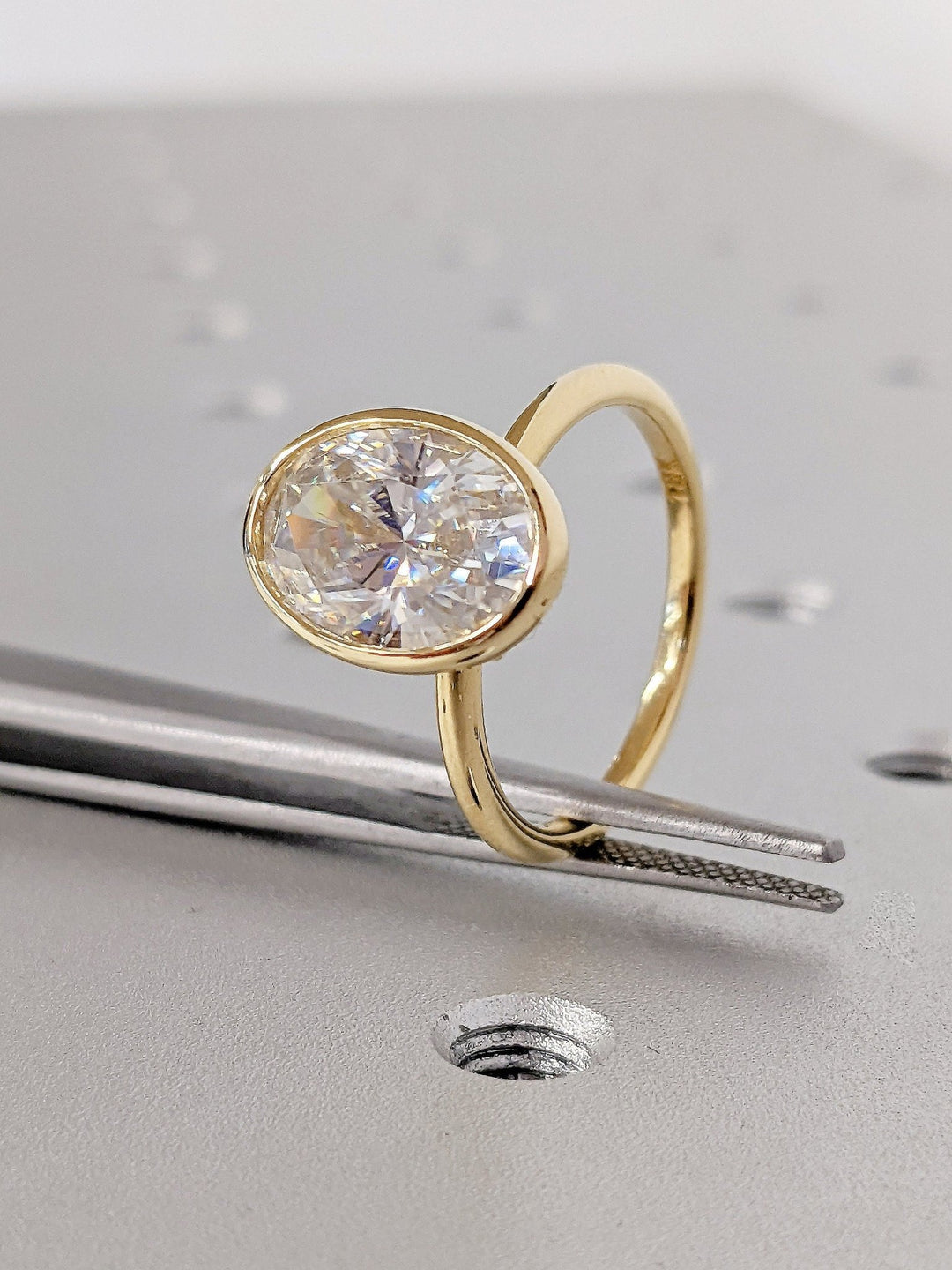 Oval bezel engagement ring with exceptional brilliance