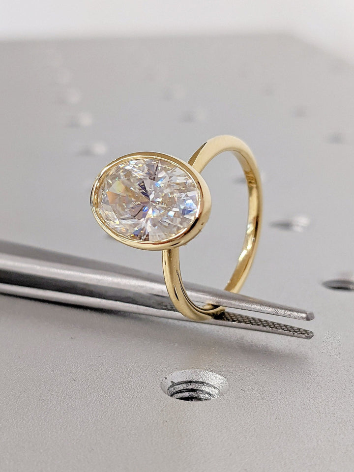 Oval bezel engagement ring with exceptional brilliance
