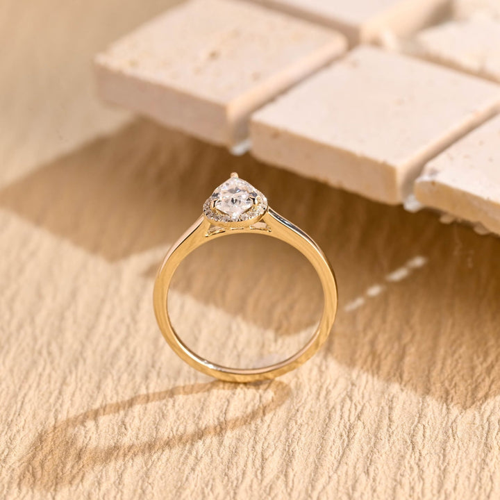 Pear halo engagement ring finished in polished solid gold