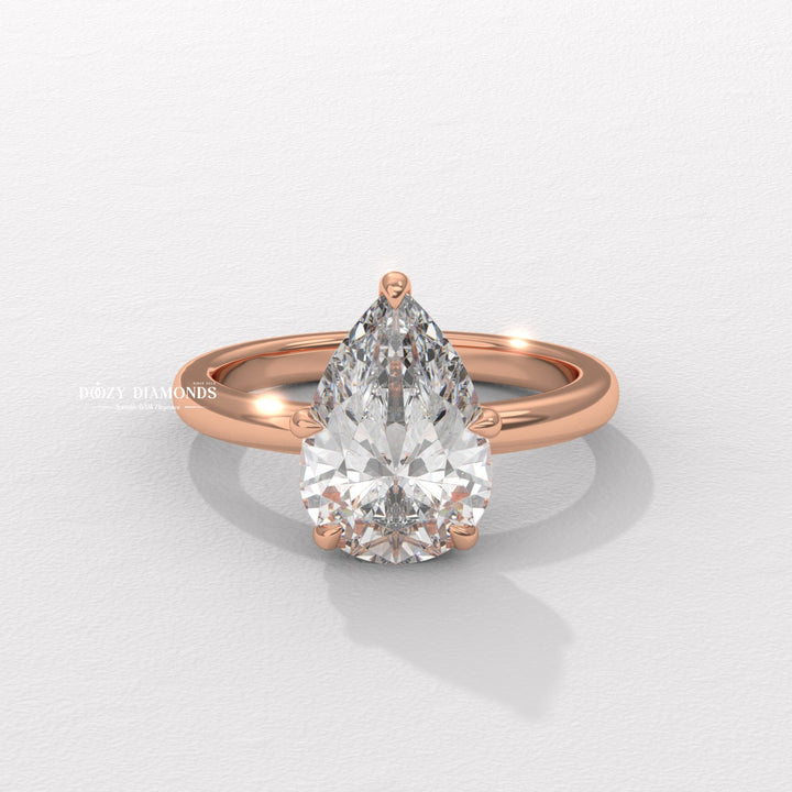 Platinum pear shaped solitaire ring
18k gold pear cut diamond ring
Timeless pear shaped engagement ring
Sparkling hidden halo diamond ring
