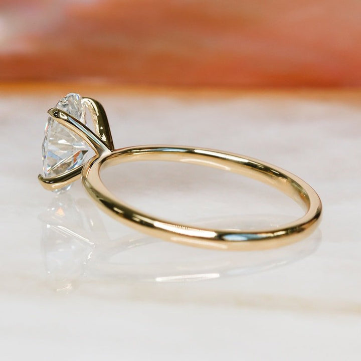 Oval solitaire lab grown diamond ring side profile in gold setting