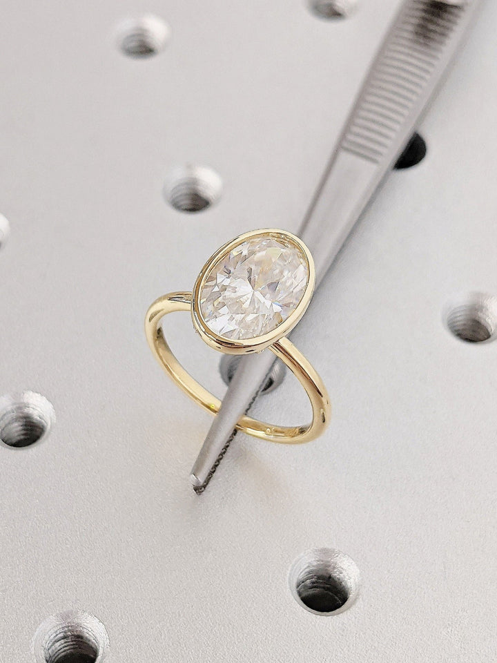 Sparkling oval diamond ring with contemporary bezel setting