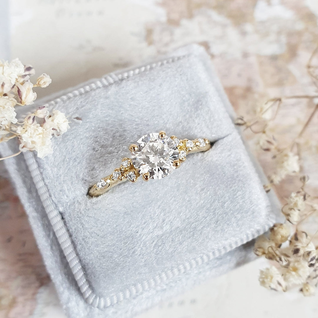 Close-up of round cut center diamond in pave engagement ring