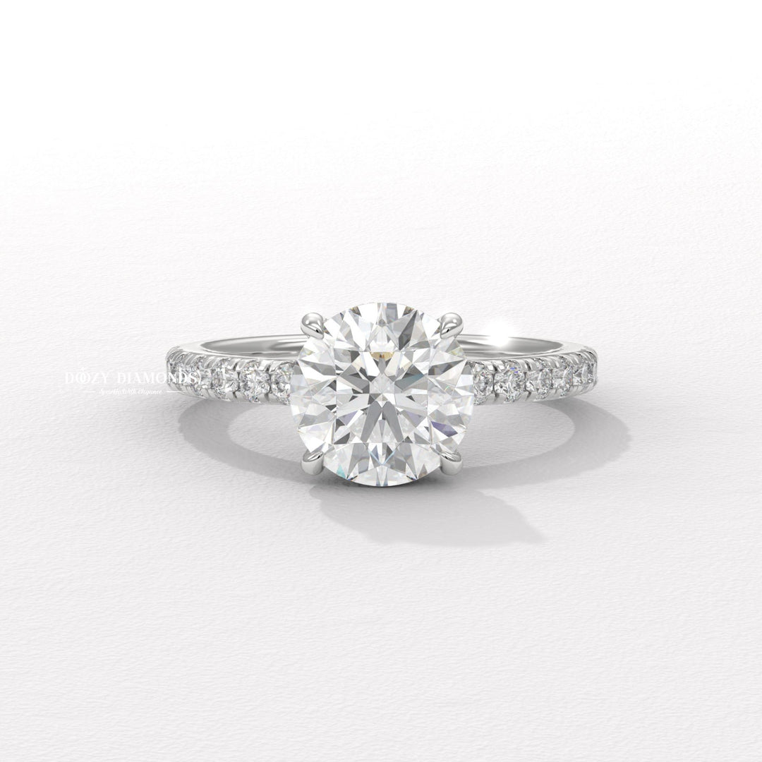 round center stone ring, round brilliant engagement ring, brilliant cut diamond ring, diamond wedding ring, engagement jewelry, bridal accessories, luxury bridal ring, handcrafted engagement ring, fine diamond jewelry, sparkling diamond ring, sparkling bridal ring, forever love ring, designer engagement ring, heirloom engagement ring, sophisticated diamond ring,