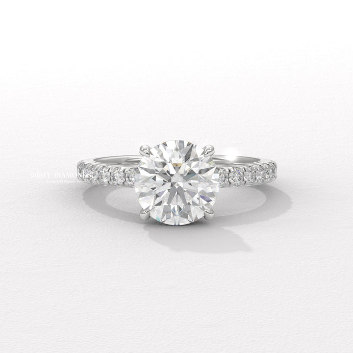 round center stone ring, round brilliant engagement ring, brilliant cut diamond ring, diamond wedding ring, engagement jewelry, bridal accessories, luxury bridal ring, handcrafted engagement ring, fine diamond jewelry, sparkling diamond ring, sparkling bridal ring, forever love ring, designer engagement ring, heirloom engagement ring, sophisticated diamond ring,