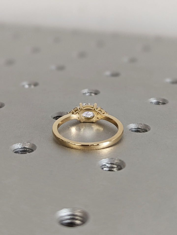 east west oval cut proposal ring,
