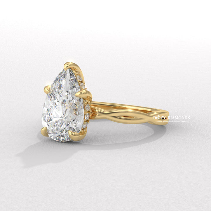 classic engagement ring, modern engagement ring, romantic proposal ring, pear center stone ring, elongated diamond ring, engagement jewelry, bridal accessories, luxury bridal ring, handcrafted engagement ring, fine diamond jewelry, sparkling diamond ring, sparkling bridal ring,