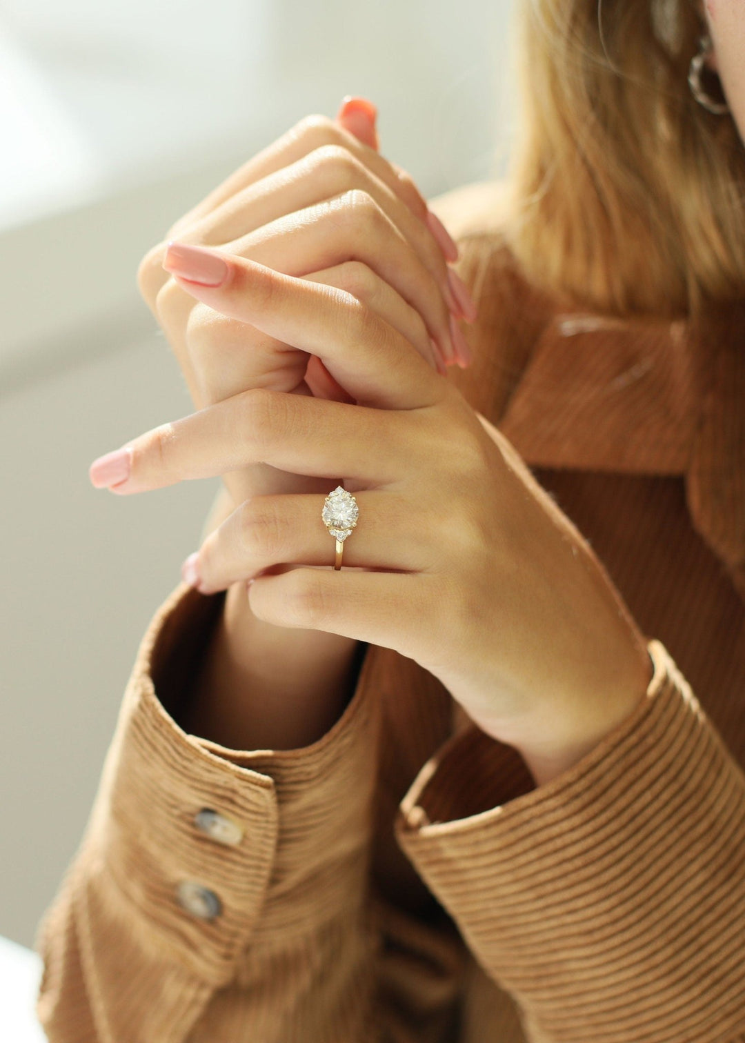 round cut engagement ring with cluster setting,