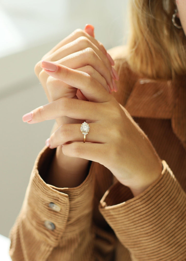 round cut engagement ring with cluster setting,